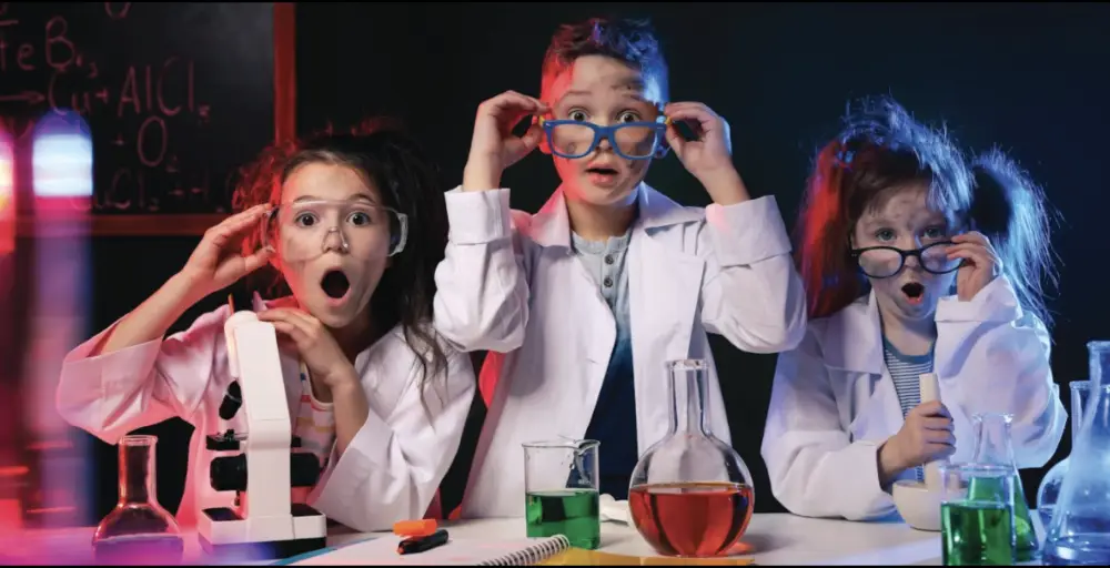 the children engages in science with beakers filled with coloured liquids