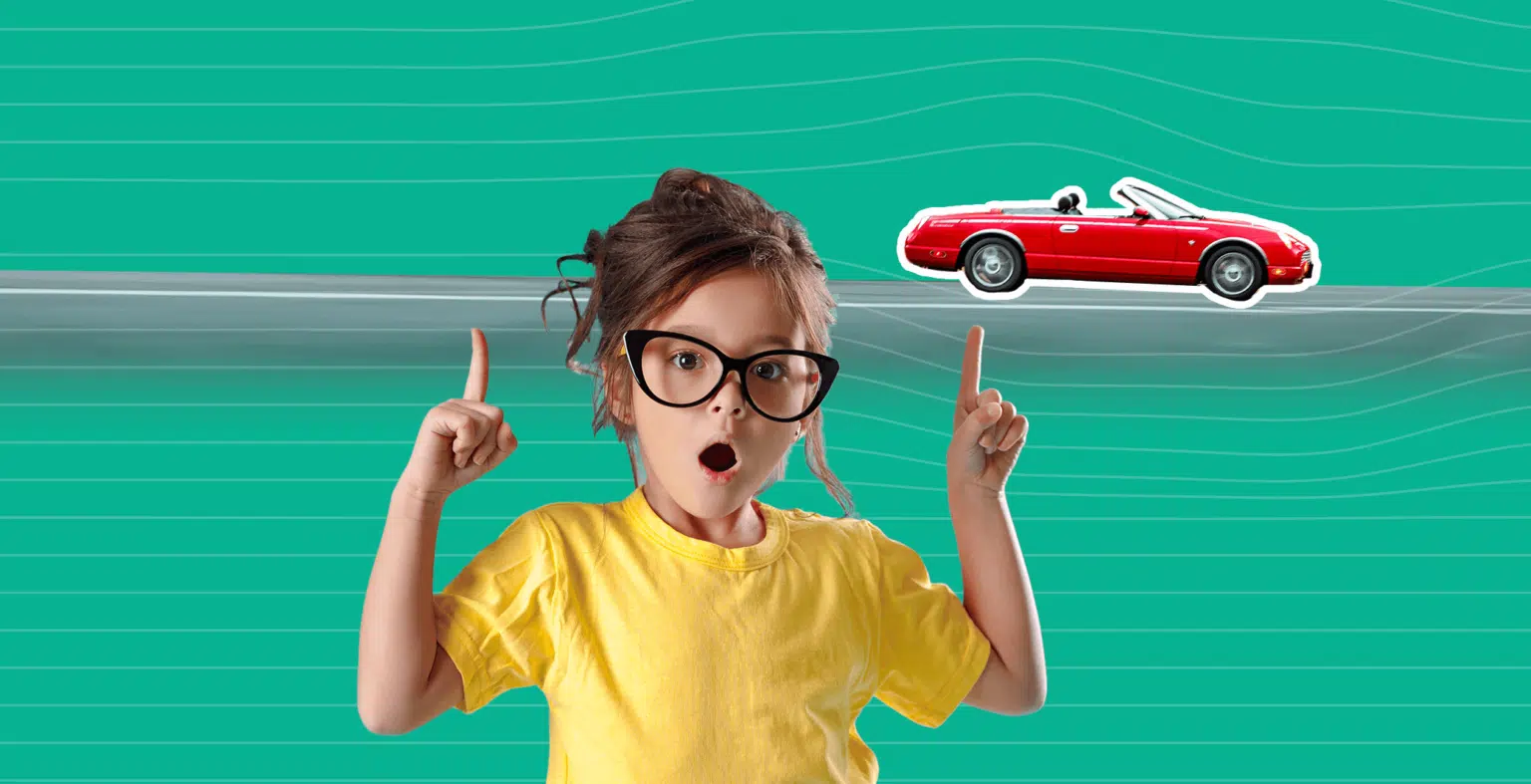 Little girl with glasses and yellow shirt points to red car driving in the green background