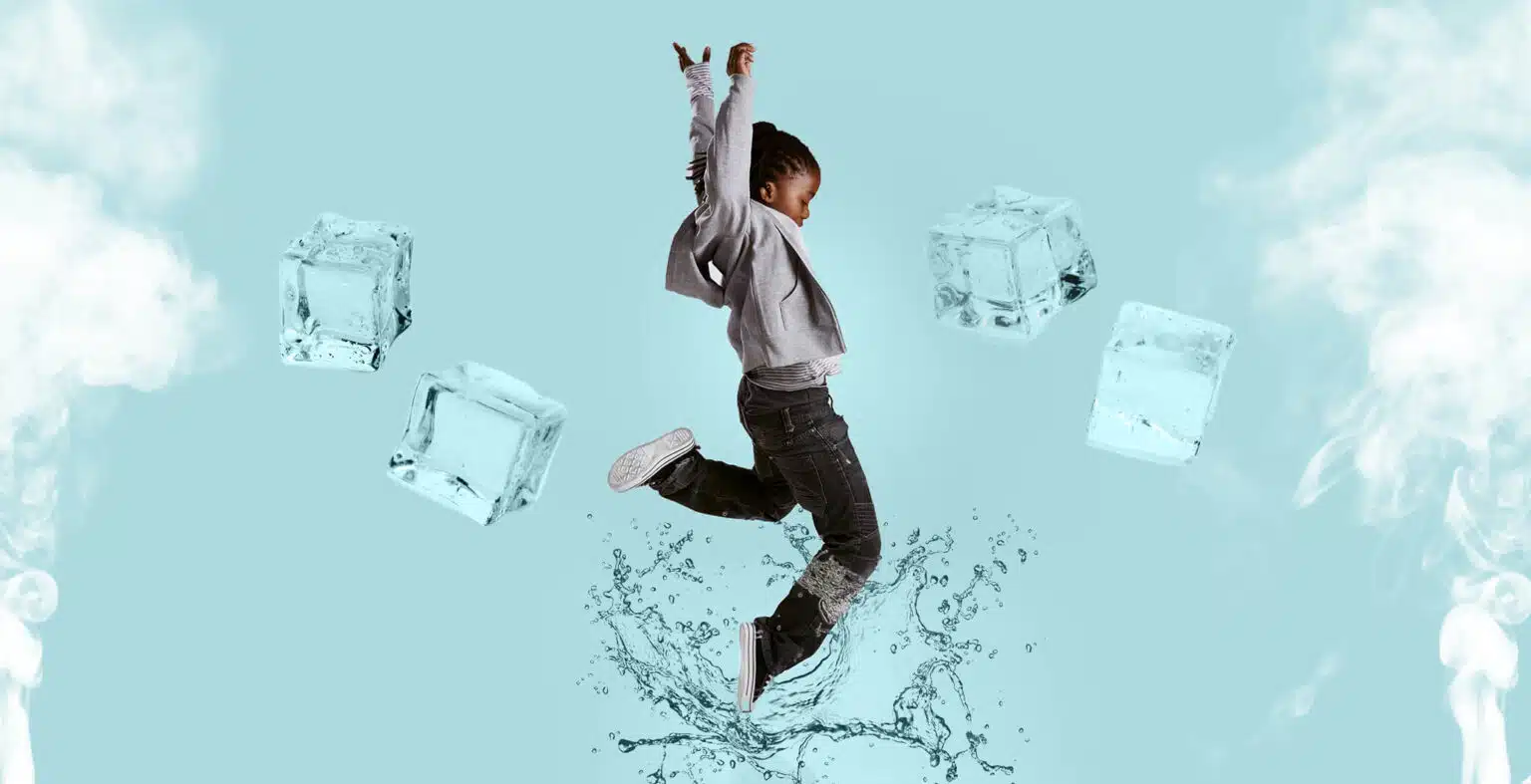 young child jumps in liquid with ice blocks floating in the sky