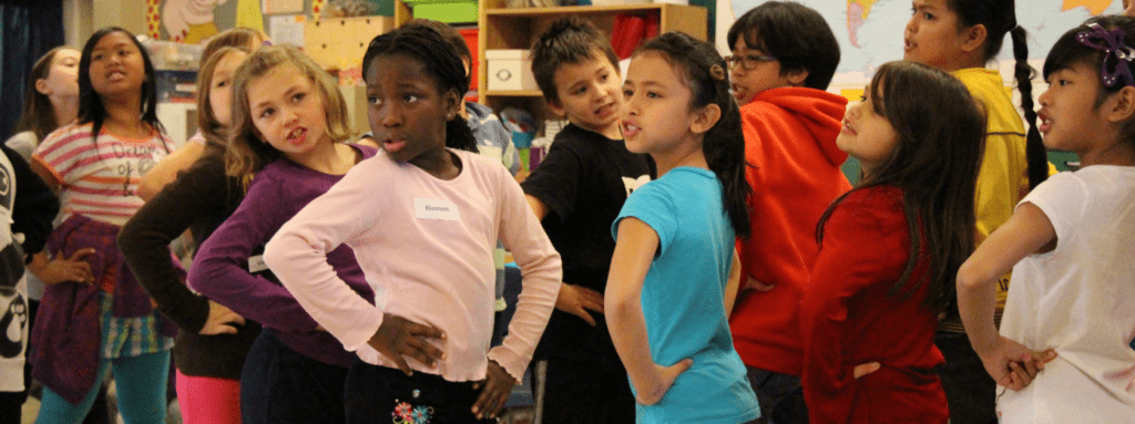 children pose with their hands on their hips
