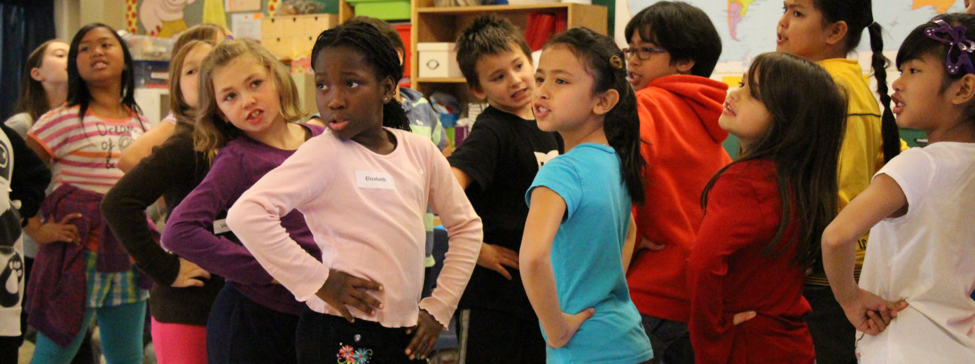 children pose with their hands on their hips