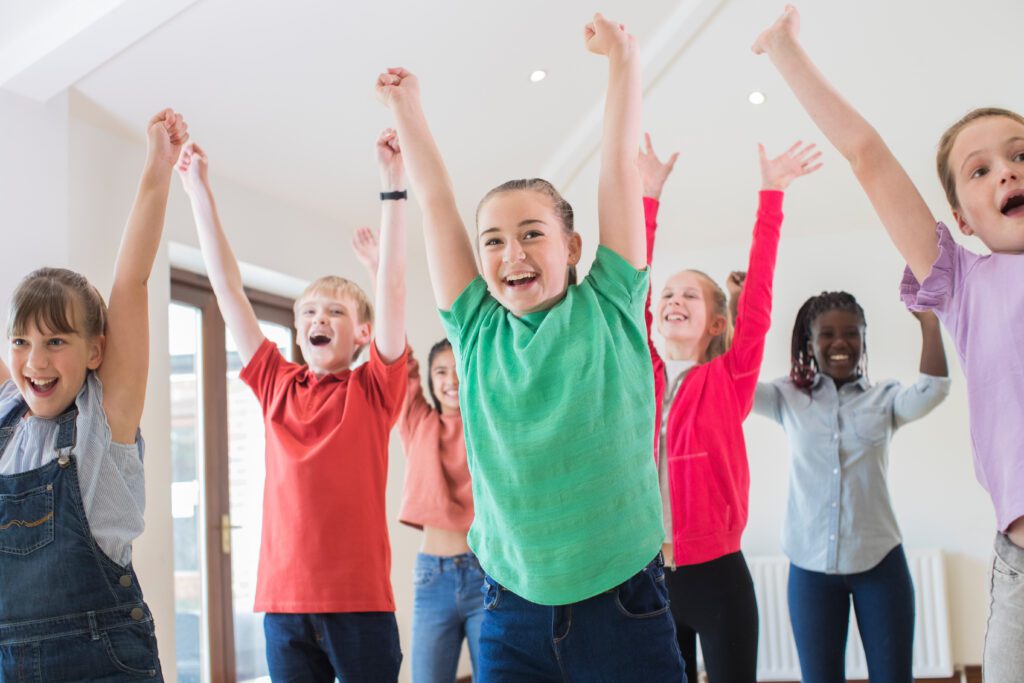 Group Of Children Enjoying Drama Class Together