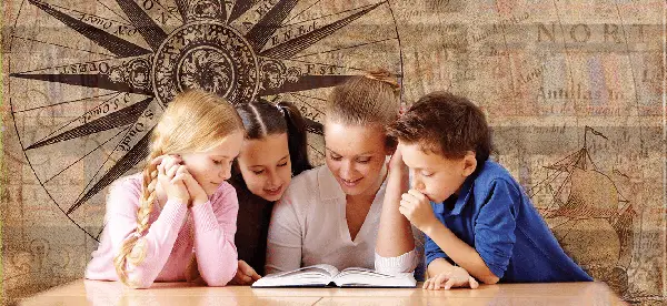 Teacher and three students read a book together with brown atlas map in the background